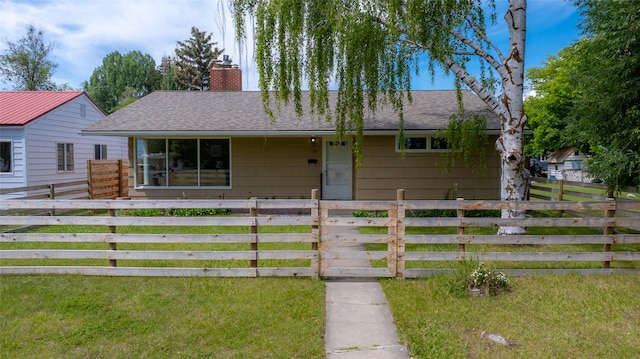 1120 8th Ave E, Kalispell, MT 59901 - view of front of property featuring roof with shingles, a fenced front yard, a chimney, and covered porch