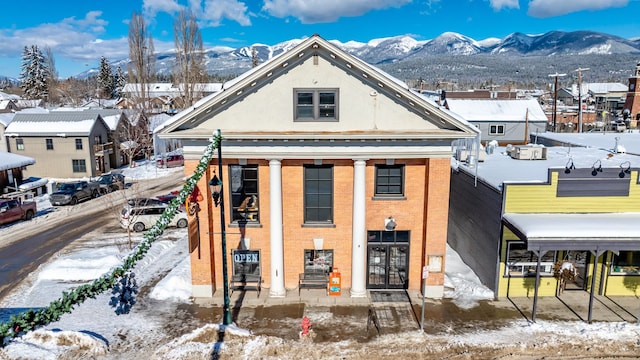 300 2nd St E Unit 2, Whitefish, MT 59937 - view of front of property with a mountain view, brick siding, stucco siding, and french doors