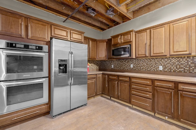 300 2nd St E Unit 2, Whitefish, MT 59937 - kitchen featuring appliances with stainless steel finishes, light countertops, backsplash, and brown cabinets