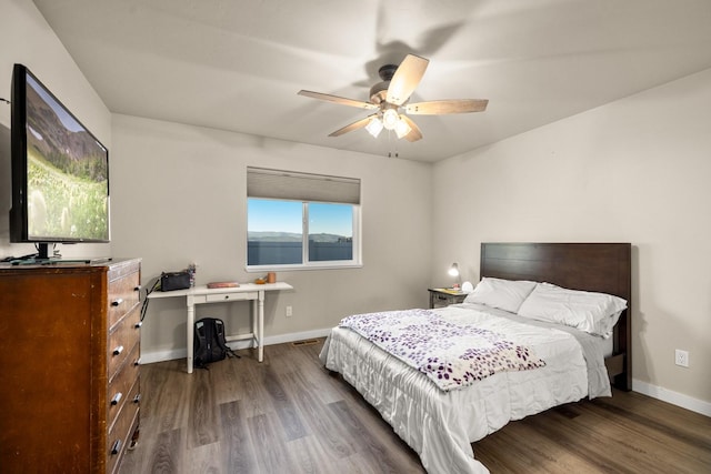 546 Sparrow Rd, Kalispell, MT 59901 - bedroom with dark wood-type flooring, a ceiling fan, and a desk