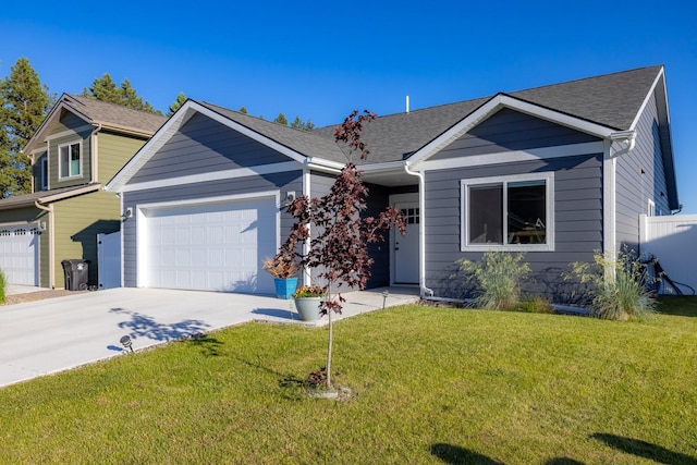 546 Sparrow Rd, Kalispell, MT 59901 - view of front facade featuring driveway, a front lawn, a garage, and a shingled roof