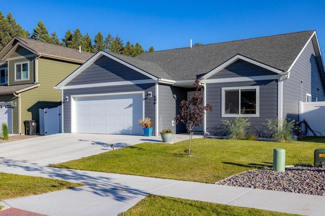 546 Sparrow Rd, Kalispell, MT 59901 - view of front facade featuring an attached garage, driveway, and a shingled roof