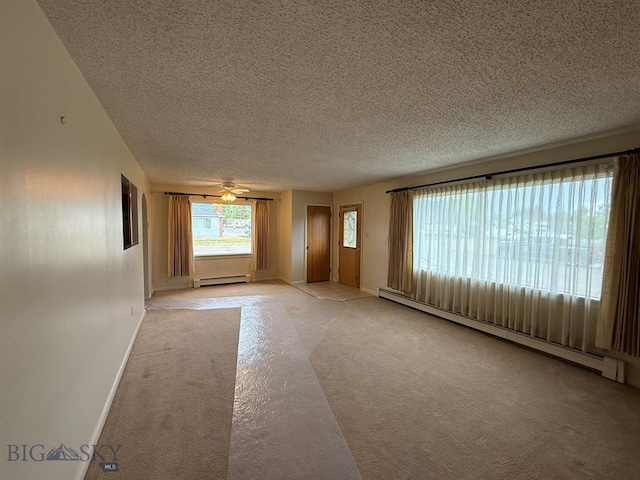 2625 George St, Butte, MT 59701 - spare room featuring baseboard heating, a textured ceiling, light colored carpet, and ceiling fan