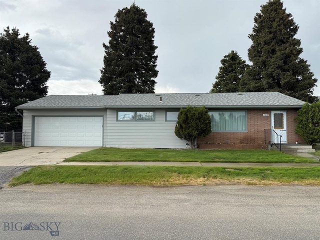 2625 George St, Butte, MT 59701 - ranch-style house with driveway, an attached garage, and a front lawn