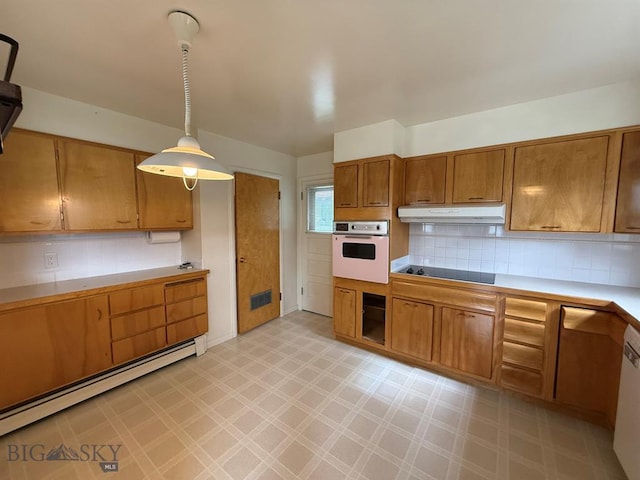 2625 George St, Butte, MT 59701 - kitchen featuring oven, black electric cooktop, under cabinet range hood, light flooring, and baseboard heating