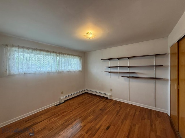 2625 George St, Butte, MT 59701 - empty room with baseboard heating and wood finished floors