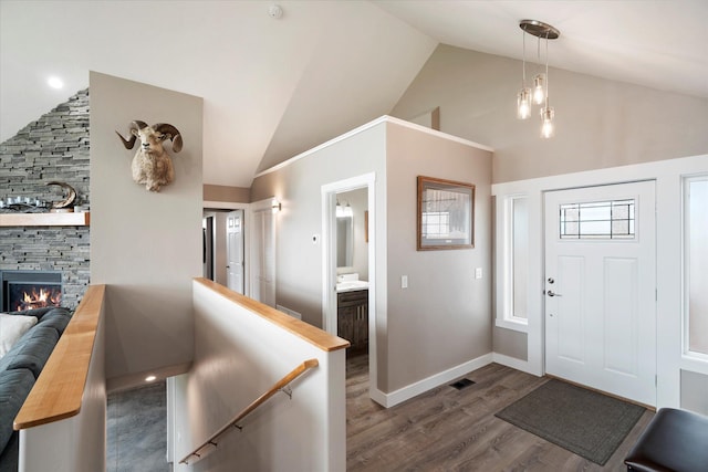 132 Skyview Ln, Polson, MT 59860 - foyer featuring high vaulted ceiling, dark wood-style floors, and a stone fireplace