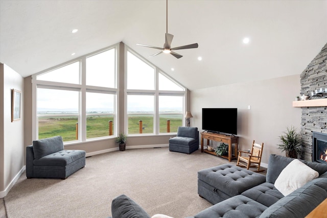 132 Skyview Ln, Polson, MT 59860 - carpeted living room featuring a fireplace, a ceiling fan, high vaulted ceiling, and recessed lighting