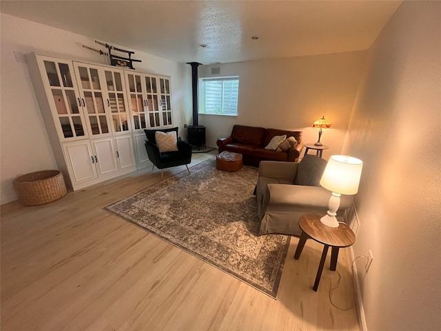 1346 Lilly Ct, Missoula, MT 59802 - living area featuring wood finished floors and a wood stove