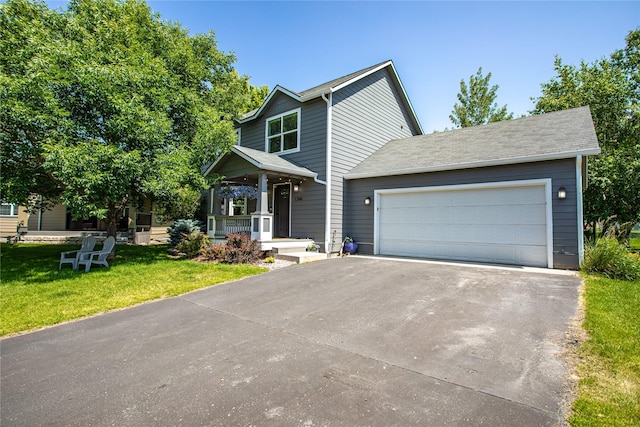 1346 Lilly Ct, Missoula, MT 59802 - view of front facade with driveway, a front lawn, an attached garage, and a porch