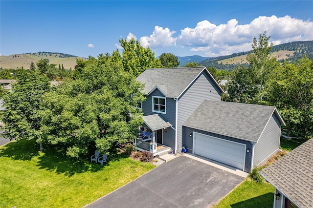 1346 Lilly Ct, Missoula, MT 59802 - view of front of house featuring driveway, an attached garage, a front yard, and a mountain view