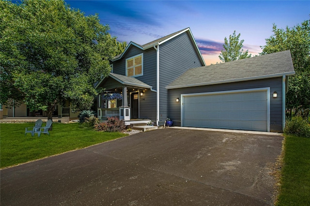 1346 Lilly Ct, Missoula, MT 59802 - view of front of property featuring covered porch, a lawn, driveway, and a garage