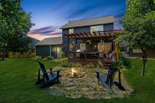 1346 Lilly Ct, Missoula, MT 59802 - rear view of property featuring a fire pit, a pergola, a wooden deck, and a shingled roof