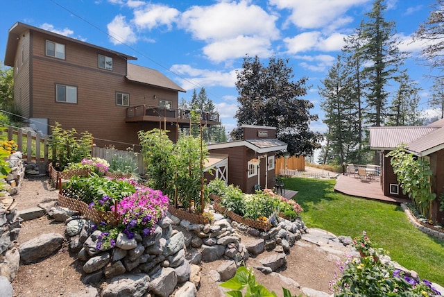 14980 Mt Highway 35, Bigfork, MT 59911 - view of yard with a wooden deck and a storage unit
