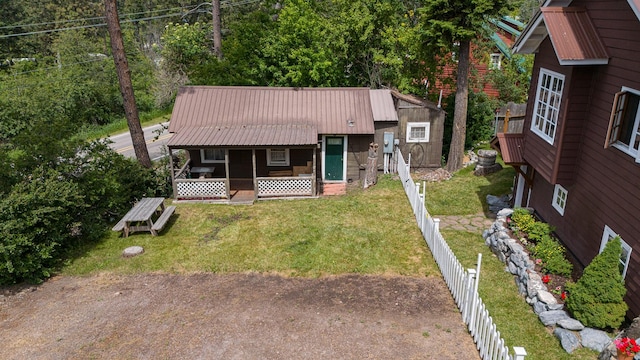 14980 Mt Highway 35, Bigfork, MT 59911 - view of front facade featuring a fenced backyard, a metal roof, and covered porch