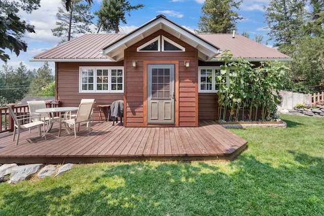 14980 Mt Highway 35, Bigfork, MT 59911 - rear view of property featuring a deck, a metal roof, and outdoor dining space