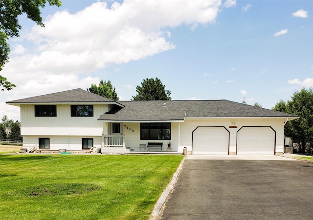 4400 Sierra Dr, Missoula, MT 59804 - split level home with driveway, a garage, a porch, a front lawn, and roof with shingles