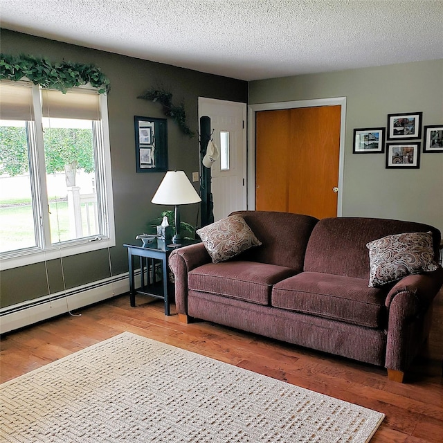 4400 Sierra Dr, Missoula, MT 59804 - living area with wood finished floors, baseboard heating, and a textured ceiling