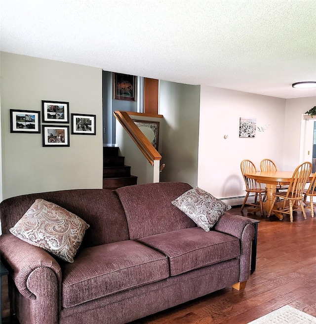 4400 Sierra Dr, Missoula, MT 59804 - living room featuring wood finished floors, stairs, a textured ceiling, and a baseboard radiator