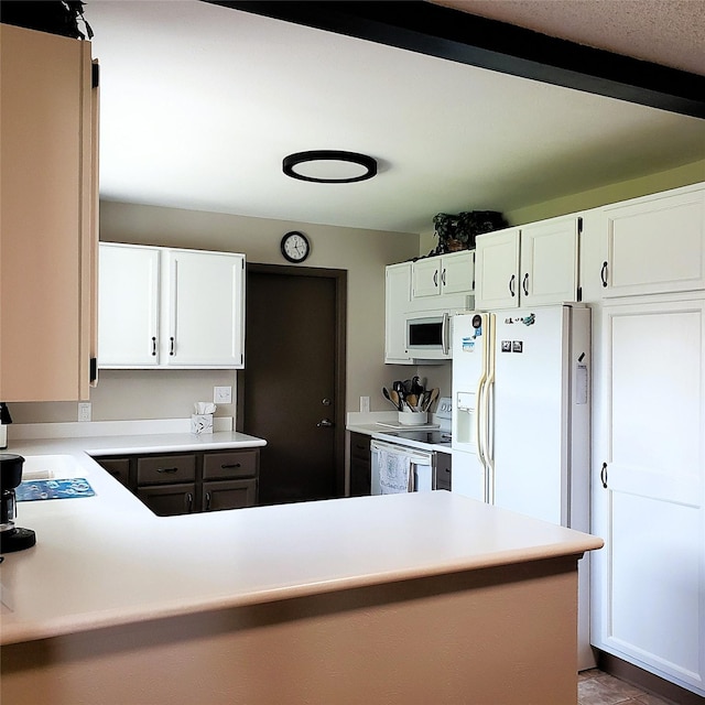 4400 Sierra Dr, Missoula, MT 59804 - kitchen featuring white appliances, light countertops, white cabinetry, and a peninsula