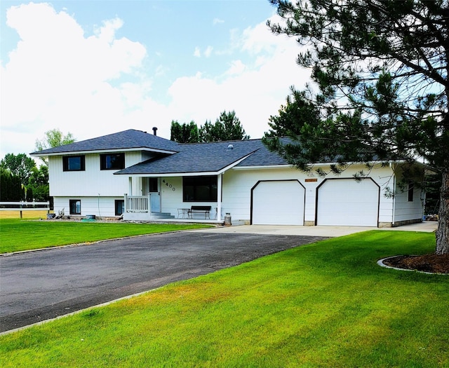 4400 Sierra Dr, Missoula, MT 59804 - split level home with a porch, asphalt driveway, a garage, a front lawn, and roof with shingles