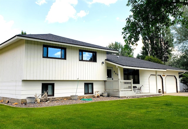4400 Sierra Dr, Missoula, MT 59804 - back of property featuring an attached garage, a lawn, covered porch, and concrete driveway