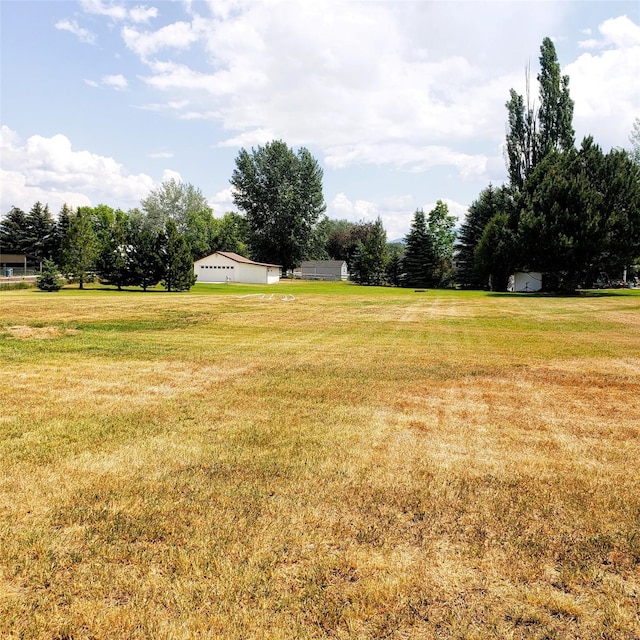 4400 Sierra Dr, Missoula, MT 59804 - view of green lawn with a detached garage