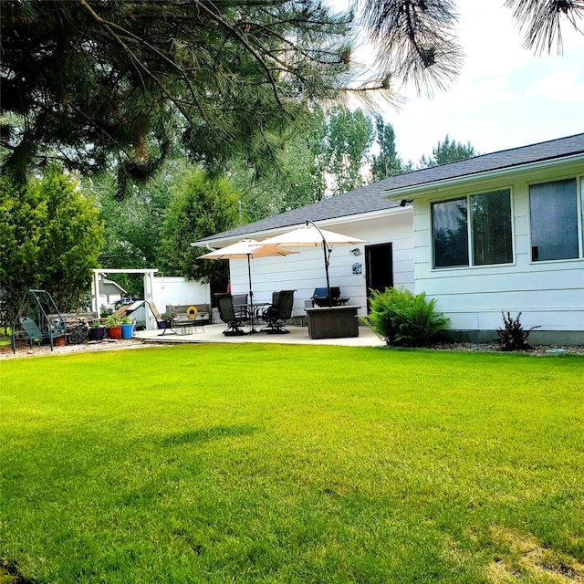 4400 Sierra Dr, Missoula, MT 59804 - rear view of house featuring a patio, a lawn, and roof with shingles
