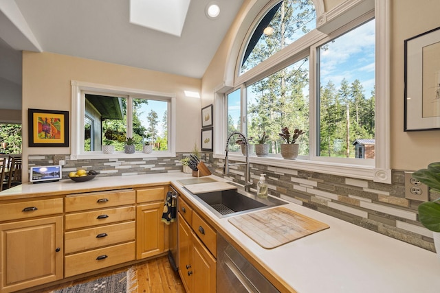 35AND33 Lakeside Ave, Lakeside, MT 59922 - kitchen featuring tasteful backsplash, light countertops, light wood finished floors, lofted ceiling, and a skylight
