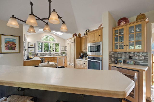 35AND33 Lakeside Ave, Lakeside, MT 59922 - kitchen featuring built in appliances, tasteful backsplash, light countertops, lofted ceiling, and beverage cooler
