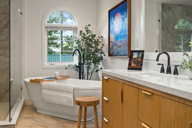 35AND33 Lakeside Ave, Lakeside, MT 59922 - bathroom featuring marble finish floors, vanity, a freestanding bath, and an enclosed shower