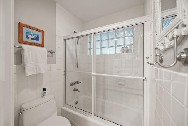 35AND33 Lakeside Ave, Lakeside, MT 59922 - bathroom with tile walls, combined bath / shower with glass door, and healthy amount of natural light