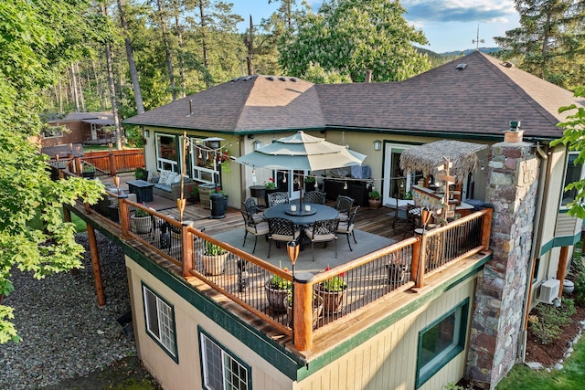 35AND33 Lakeside Ave, Lakeside, MT 59922 - rear view of house with a wooden deck, a shingled roof, and outdoor dining space