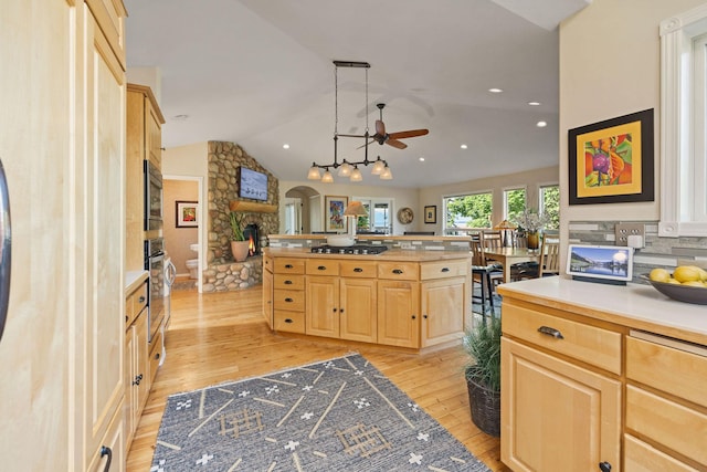35AND33 Lakeside Ave, Lakeside, MT 59922 - kitchen featuring light brown cabinetry, a ceiling fan, light wood finished floors, arched walkways, and vaulted ceiling