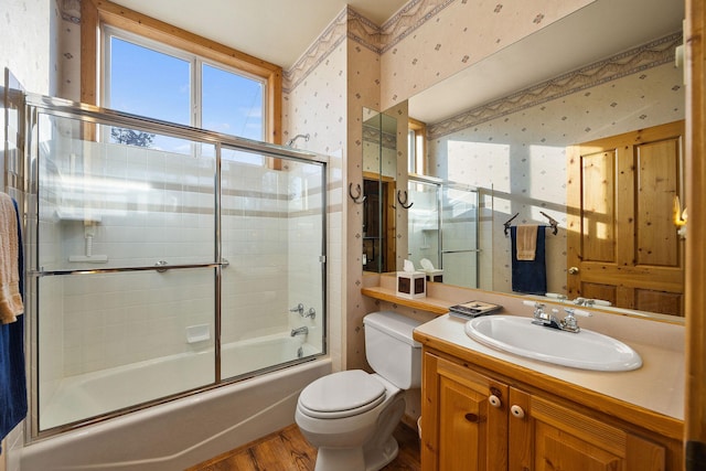 35AND33 Lakeside Ave, Lakeside, MT 59922 - bathroom featuring wallpapered walls, wood finished floors, combined bath / shower with glass door, and vanity