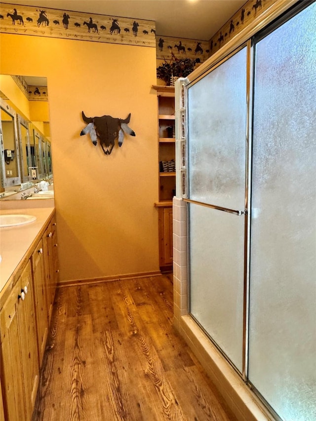 35AND33 Lakeside Ave, Lakeside, MT 59922 - full bath featuring vanity, wood finished floors, and a shower with shower door