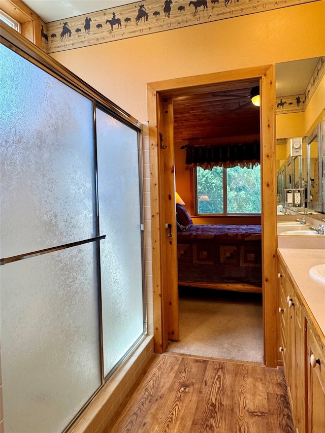 35AND33 Lakeside Ave, Lakeside, MT 59922 - ensuite bathroom featuring wood finished floors, vanity, and a stall shower