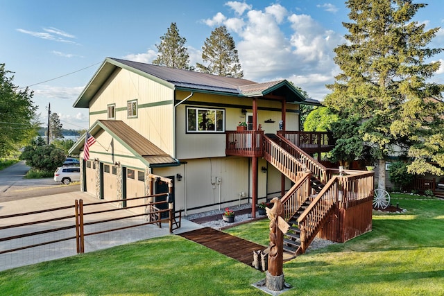 35AND33 Lakeside Ave, Lakeside, MT 59922 - view of front facade with a metal roof, driveway, an attached garage, stairway, and a deck