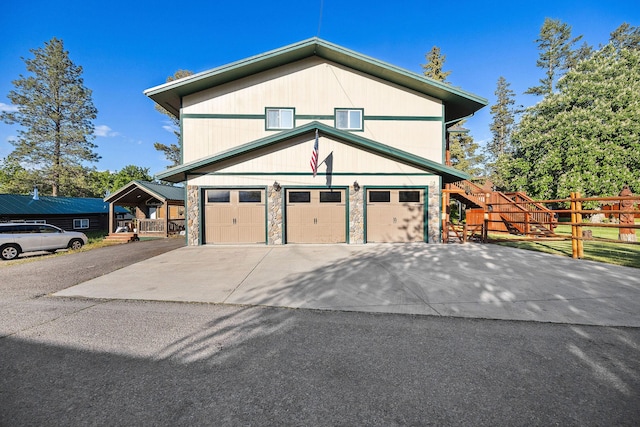 35AND33 Lakeside Ave, Lakeside, MT 59922 - view of property exterior with asphalt driveway, stone siding, and a garage