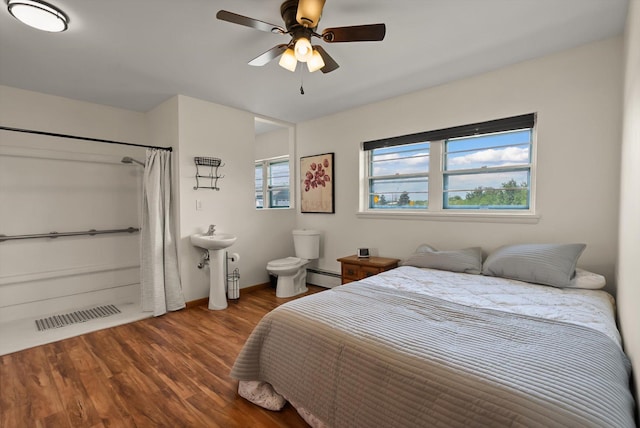 91 Denver Ave, Kalispell, MT 59901 - bedroom with baseboard heating, wood finished floors, and a ceiling fan