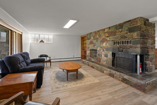 91 Denver Ave, Kalispell, MT 59901 - living area with a baseboard heating unit, wood finished floors, a fireplace, and built in shelves