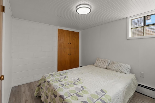 91 Denver Ave, Kalispell, MT 59901 - bedroom featuring a baseboard heating unit and wood finished floors