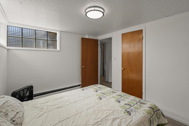 91 Denver Ave, Kalispell, MT 59901 - bedroom with a baseboard heating unit and wood finished floors