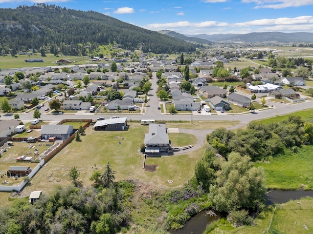 91 Denver Ave, Kalispell, MT 59901 - aerial overview of property's location featuring a mountainous background and nearby suburban area
