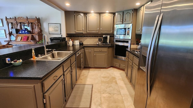 122 Fairway Blvd, Kalispell, MT 59901 - kitchen with stainless steel appliances, dark countertops, recessed lighting, decorative backsplash, and a peninsula