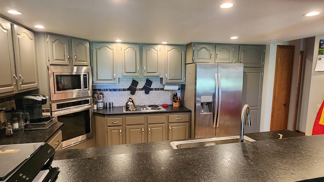 122 Fairway Blvd, Kalispell, MT 59901 - kitchen with appliances with stainless steel finishes, dark countertops, tasteful backsplash, and recessed lighting