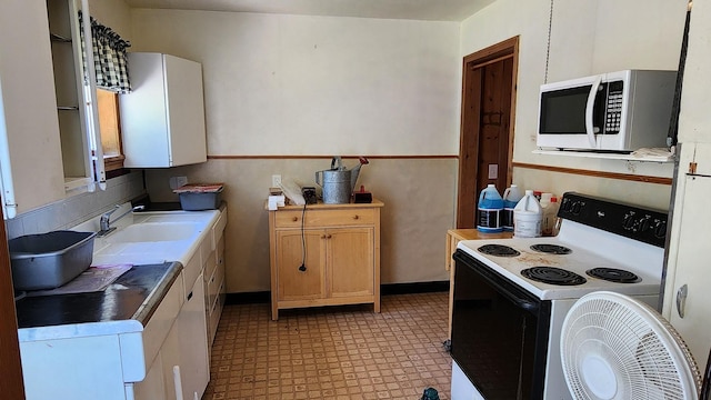 21439 Rollins Lakeshore Dr, Rollins, MT 59931 - kitchen featuring electric range oven, white microwave, and light floors