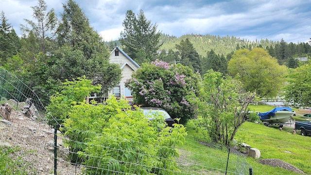 21439 Rollins Lakeshore Dr, Rollins, MT 59931 - view of grassy yard with a view of trees