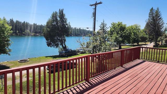 21439 Rollins Lakeshore Dr, Rollins, MT 59931 - wooden terrace featuring a water view and a lawn