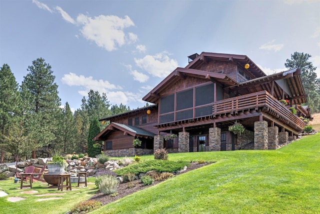 349 Harlan Creek Rd, Hamilton, MT 59840 - back of property with stone siding, a lawn, and a wooden deck